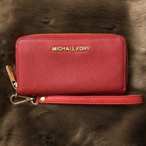 Red Michael Kors wallet with wrist strap